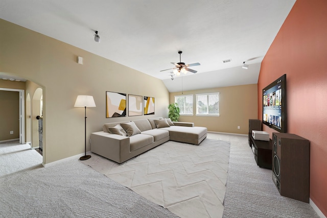 11014 Via Capri Ct, Richmond, TX 77406 - living area featuring light colored carpet, arched walkways, a ceiling fan, vaulted ceiling, and baseboards