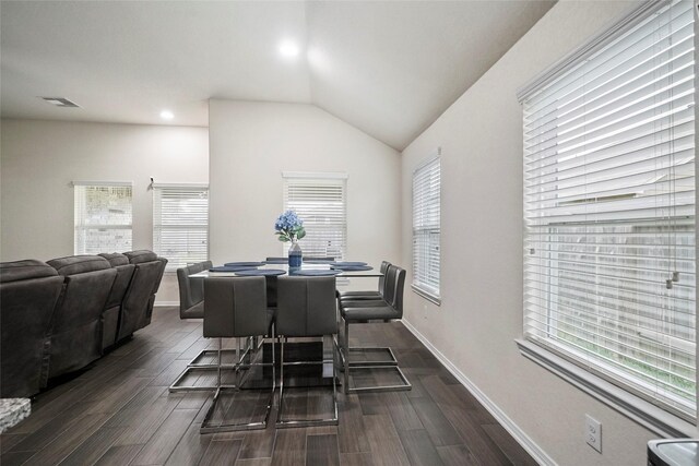 dining area with dark wood finished floors, vaulted ceiling, baseboards, and recessed lighting