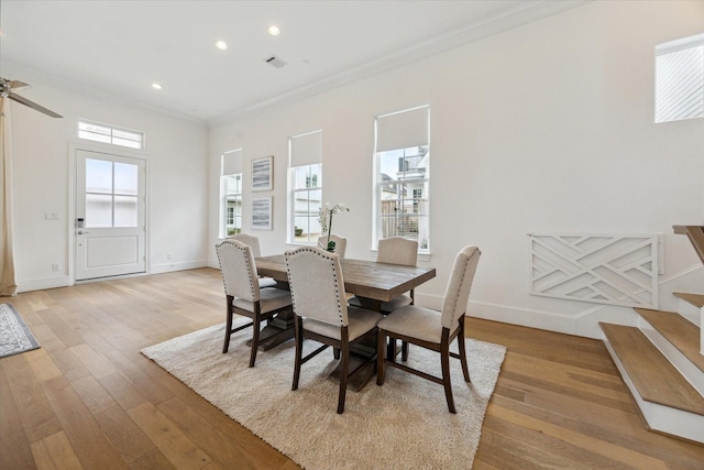 dining room with crown molding, recessed lighting, baseboards, and light wood finished floors