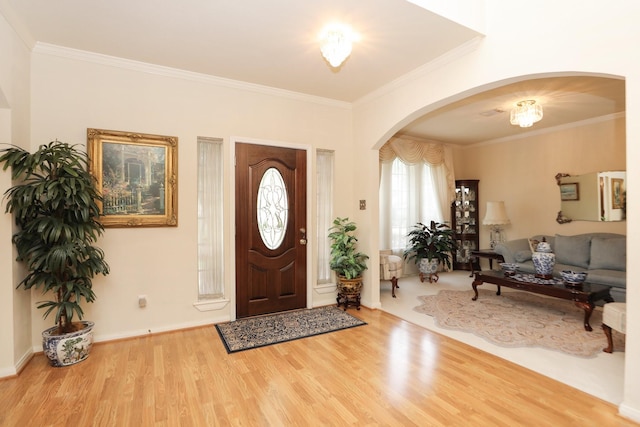 12219 Renaissance Ln, Houston, TX 77071 - foyer entrance with arched walkways, ornamental molding, baseboards, and wood finished floors