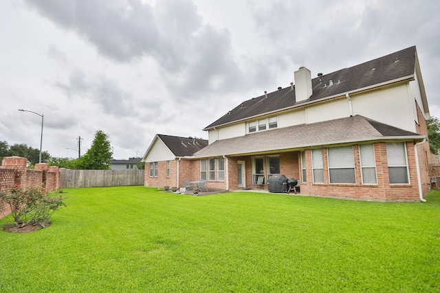 12219 Renaissance Ln, Houston, TX 77071 - back of house with brick siding, a fenced backyard, a yard, a patio, and a shingled roof