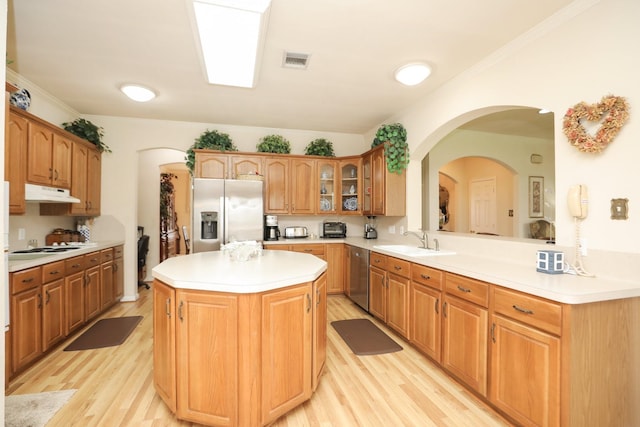 12219 Renaissance Ln, Houston, TX 77071 - kitchen with appliances with stainless steel finishes, a sink, under cabinet range hood, visible vents, and glass insert cabinets