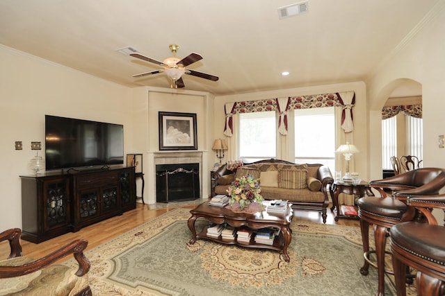 12219 Renaissance Ln, Houston, TX 77071 - living room featuring ceiling fan, visible vents, arched walkways, wood finished floors, and ornamental molding