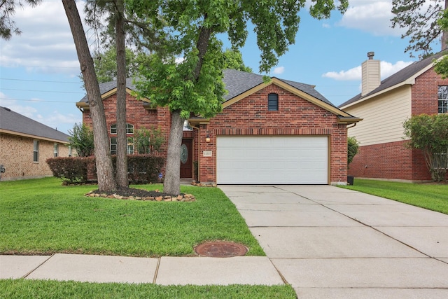 traditional home featuring an attached garage, driveway, a front lawn, and brick siding