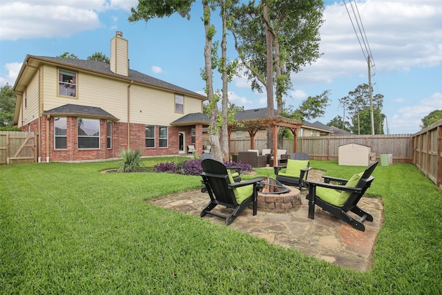 rear view of house with a pergola, an outdoor fire pit, brick siding, a fenced backyard, and a chimney