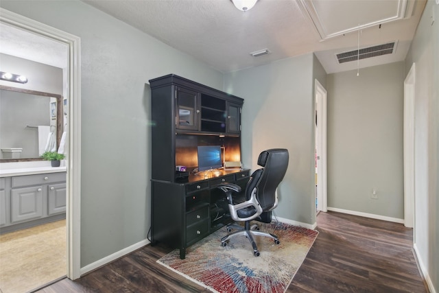 office space featuring baseboards, visible vents, wood finished floors, and attic access