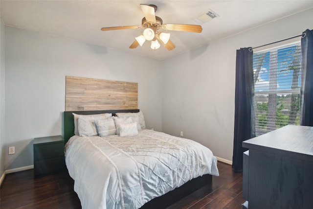 bedroom featuring a ceiling fan, baseboards, visible vents, and dark wood-style floors