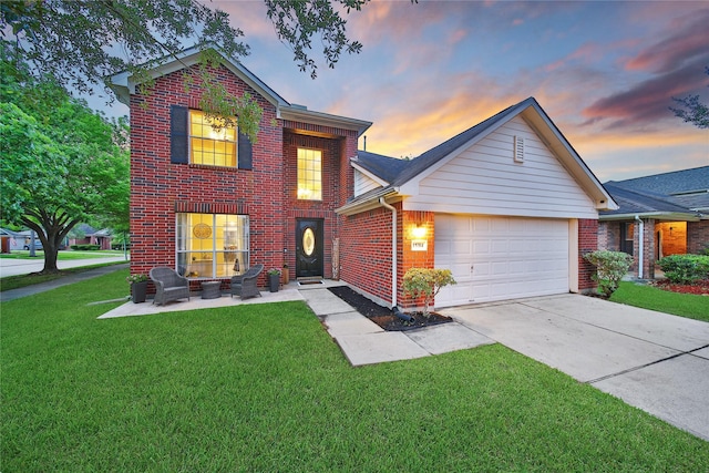 traditional-style home with an attached garage, concrete driveway, brick siding, and a front yard