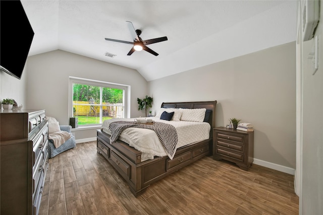 bedroom with visible vents, wood finished floors, lofted ceiling, baseboards, and ceiling fan