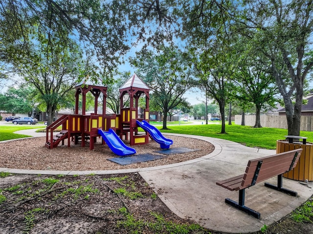 communal playground with fence and a yard