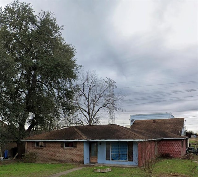 view of front of home featuring a front lawn and brick siding