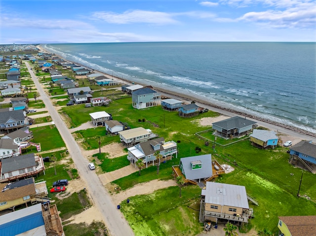 bird's eye view featuring a water view, a view of the beach, and a residential view