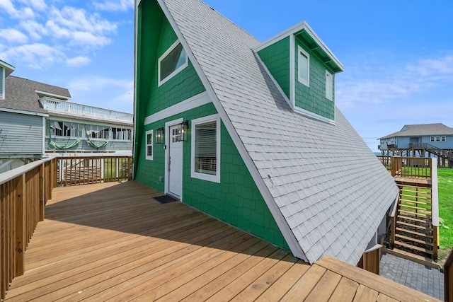 back of property featuring stairs, a shingled roof, and a deck