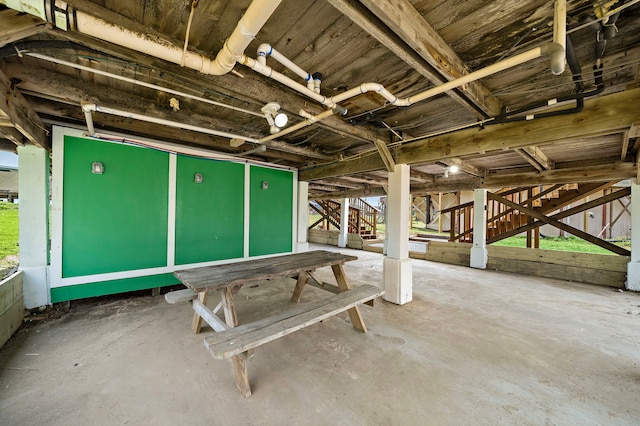 miscellaneous room with stairs and concrete floors