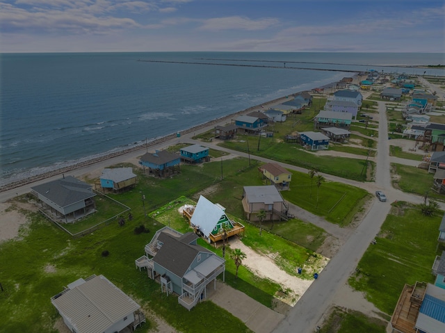 birds eye view of property with a view of the beach and a water view