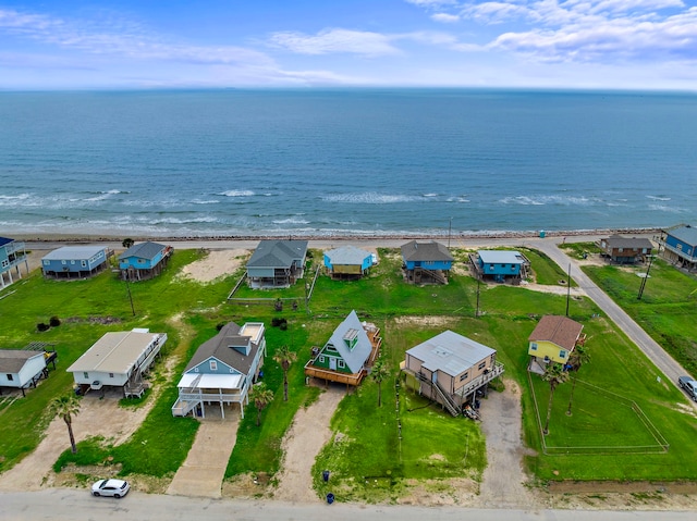 bird's eye view featuring a water view and a beach view