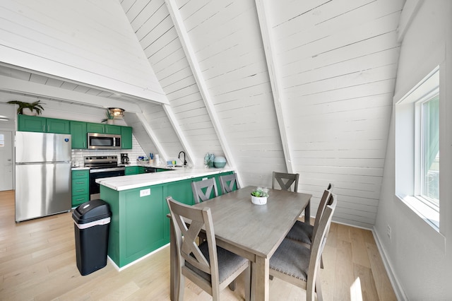 dining space with baseboards, vaulted ceiling with beams, and light wood-type flooring