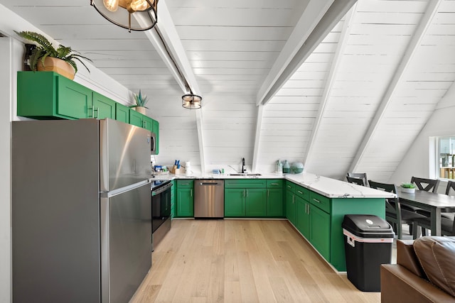 kitchen with a sink, green cabinetry, appliances with stainless steel finishes, and a peninsula