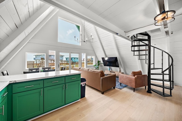 living room featuring stairs, lofted ceiling with beams, a wealth of natural light, and light wood-style flooring