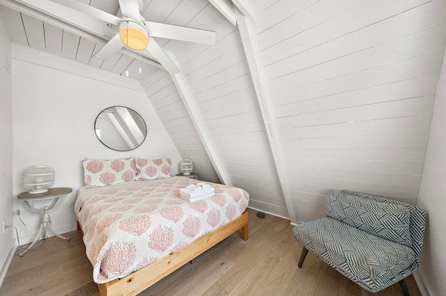 bedroom with ceiling fan, wooden ceiling, vaulted ceiling with beams, and wood finished floors