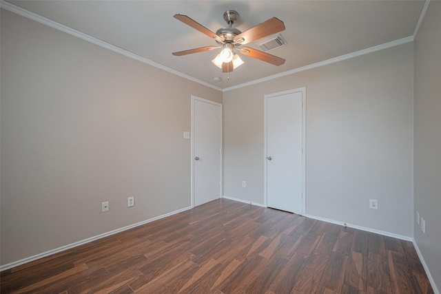 spare room with visible vents, ornamental molding, wood finished floors, baseboards, and ceiling fan