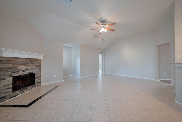 unfurnished living room with visible vents, a stone fireplace, a ceiling fan, light tile patterned floors, and vaulted ceiling