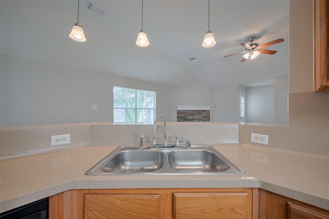kitchen with visible vents, lofted ceiling, ceiling fan, light countertops, and a sink