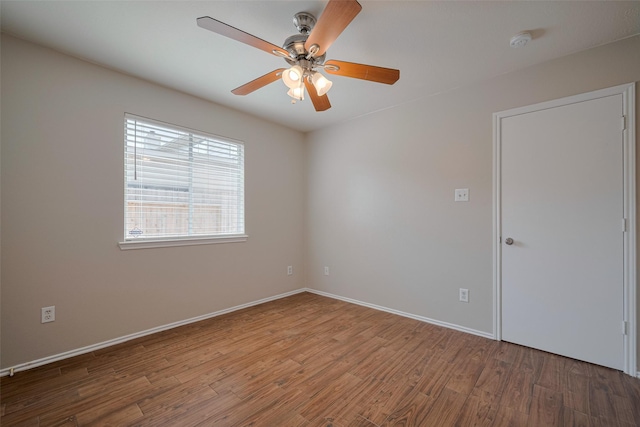 spare room featuring baseboards, a ceiling fan, and wood finished floors