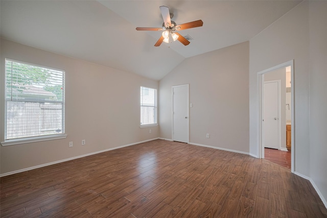 spare room featuring dark wood-style flooring, ceiling fan, and vaulted ceiling