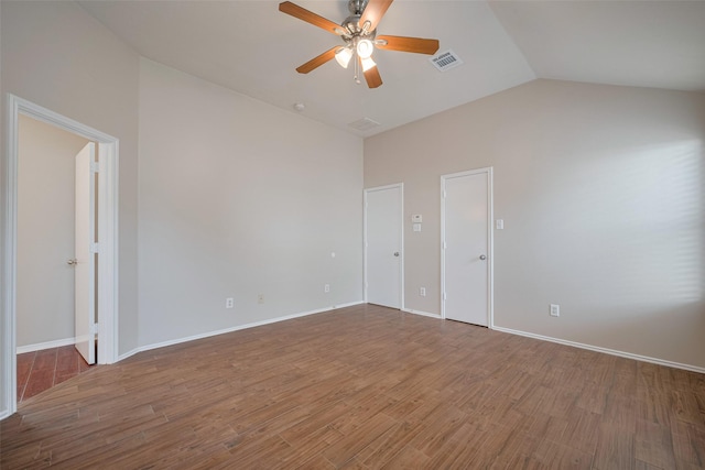 unfurnished room featuring visible vents, ceiling fan, wood finished floors, and lofted ceiling