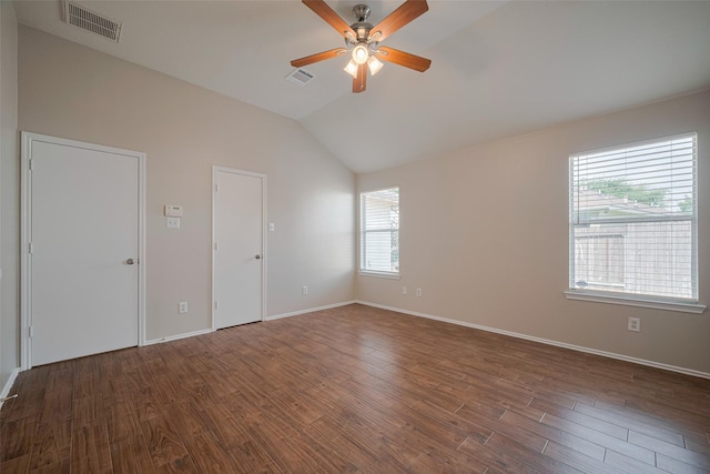 empty room with visible vents, ceiling fan, vaulted ceiling, and a healthy amount of sunlight