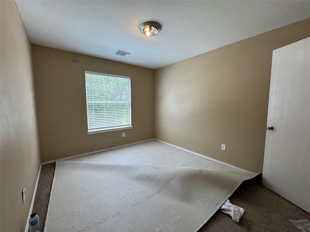 carpeted empty room with baseboards and visible vents