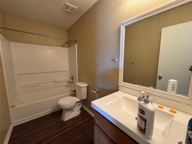 full bath with visible vents, vanity, wood finished floors, toilet, and baseboards