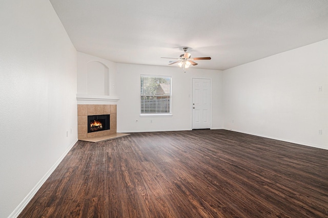 9607 Western Briar Ln, Humble, TX 77396 - unfurnished living room featuring ceiling fan, dark wood finished floors, and a tiled fireplace