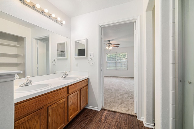 9607 Western Briar Ln, Humble, TX 77396 - full bath with double vanity, a ceiling fan, and wood finished floors