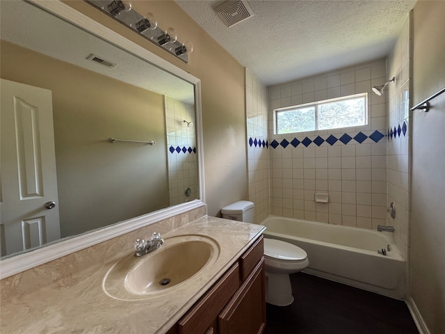 bathroom featuring vanity, shower / bathing tub combination, visible vents, and toilet