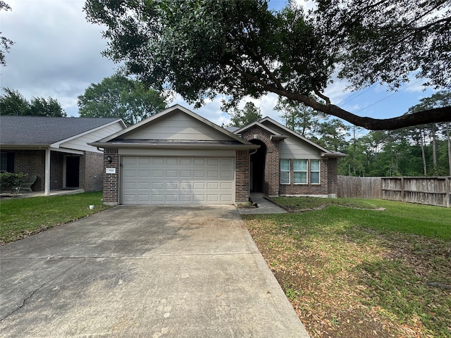 single story home featuring brick siding, fence, a front lawn, concrete driveway, and an attached garage