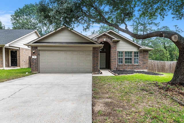 900 Summer Wood Blvd, Conroe, TX 77303 - single story home with an attached garage, brick siding, and concrete driveway