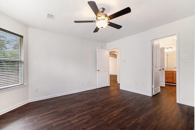 900 Summer Wood Blvd, Conroe, TX 77303 - unfurnished bedroom featuring dark wood-style floors, baseboards, and arched walkways