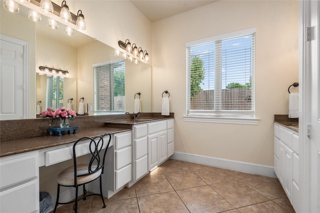 20687 Lavone Dr, Porter, TX 77365 - bathroom featuring healthy amount of natural light, vanity, tile patterned floors, and baseboards