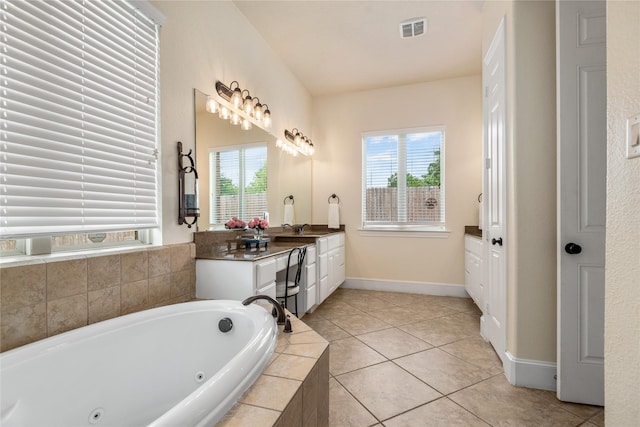 20687 Lavone Dr, Porter, TX 77365 - full bathroom with healthy amount of natural light, a whirlpool tub, vanity, and tile patterned flooring