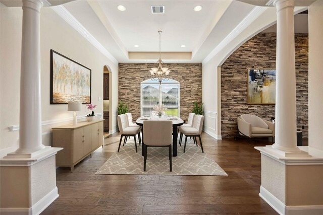 25034 Jennifer Heights Ct, Spring, TX 77389 - dining room featuring decorative columns, a notable chandelier, dark wood-style flooring, and visible vents