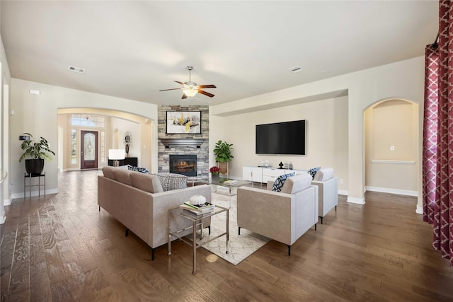 25034 Jennifer Heights Ct, Spring, TX 77389 - living room featuring ceiling fan, a fireplace, arched walkways, wood finished floors, and visible vents