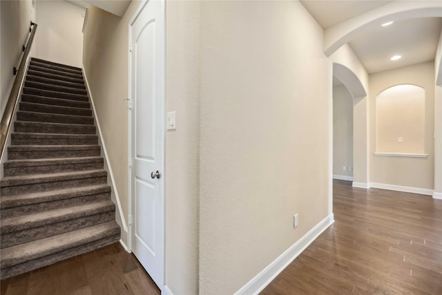 25034 Jennifer Heights Ct, Spring, TX 77389 - staircase with baseboards, arched walkways, wood finished floors, and recessed lighting