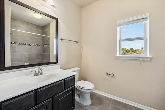 25034 Jennifer Heights Ct, Spring, TX 77389 - bathroom featuring tile patterned flooring, vanity, toilet, baseboards, and a tile shower