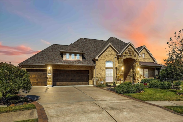 25034 Jennifer Heights Ct, Spring, TX 77389 - view of front of home featuring concrete driveway, an attached garage, a shingled roof, and stone siding