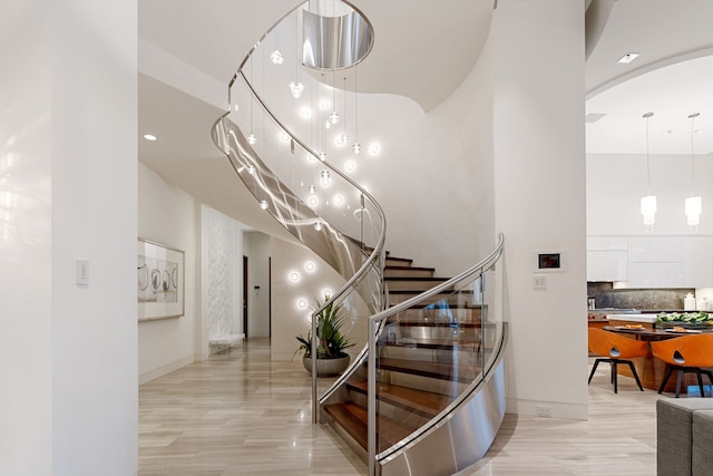 15618 Oyster Cove Dr, Sugar Land, TX 77478 - stairway with a towering ceiling, wood finished floors, and arched walkways