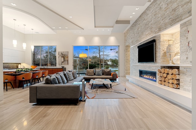 15618 Oyster Cove Dr, Sugar Land, TX 77478 - living room featuring a high ceiling, a stone fireplace, and recessed lighting