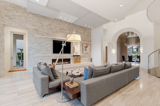 15618 Oyster Cove Dr, Sugar Land, TX 77478 - living area with arched walkways, a fireplace, and recessed lighting