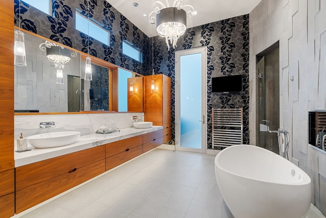 15618 Oyster Cove Dr, Sugar Land, TX 77478 - bathroom with a chandelier, a freestanding tub, a stall shower, double vanity, and a towel warming rack
